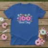 Blue t-shirt with "100 Sweet Days" text surrounded by colorful donuts and hearts, celebrating the 100th day of school