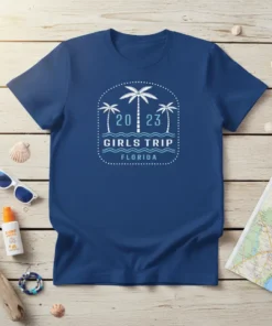 2023 Girls Trip Florida text with palm trees and waves graphic on a blue t-shirt