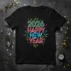 2026 Happy New Year text in vibrant neon colors with festive bursts, on a black t-shirt