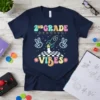2nd Grade Vibes t-shirt with retro fonts, a rocket ship, peace signs, and stars. Features colorful text and playful graphics