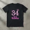 Black t-shirt with "34 It's My Birthday" text and a pink crown, designed for a 34th birthday celebration