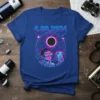 4.08.2024 The Eclipse Selfie t-shirt design featuring a person taking a selfie during a solar eclipse with cosmic background