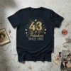 Gold glitter typography '43 & Fabulous Since 1982' with art deco burst design on a navy t-shirt