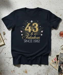 Gold glitter typography '43 & Fabulous Since 1982' with art deco burst design on a navy t-shirt