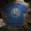 Blue t-shirt with gold distressed "45 CÓDIGO" text surrounded by steampunk gears and circuitry design