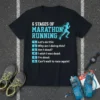Black t-shirt displaying "6 Stages of Marathon Running" with a runner graphic and humorous list of stages
