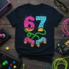 Black t-shirt with the number 67 designed as donuts and ice cream cones, connected to retro game controllers