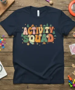 Retro "Activity Squad" text design with camping graphics, tents, and trees, featuring a vintage color palette on a navy t-shirt