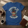 Addicted to Caffeine t-shirt design featuring a black cat sitting in stacked coffee cups