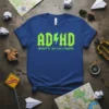 ADHD HIGHWAY TO...HEY LOOK A SQUIRREL text design on a blue t-shirt, featuring green lightning bolts within the ADHD letters