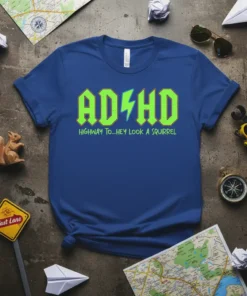ADHD HIGHWAY TO...HEY LOOK A SQUIRREL text design on a blue t-shirt, featuring green lightning bolts within the ADHD letters