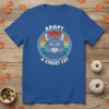 Adopt A Street Cat graphic t-shirt featuring a vintage-style cat portrait with retro sunset stripes