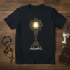 Adorable Adoration T-Shirt featuring a golden monstrance design with the word "Adorable" below, symbolizing Catholic faith and religious apparel