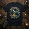 Adventure Awaits Music Under The Stars text with acoustic guitar, moon, and forest graphic on a t-shirt