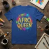 Afro Queen t-shirt design with bold golden lettering and colorful floral and paint splatter graphics
