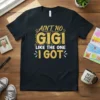 Ain't No Gigi Like The One I Got quote on a black t-shirt, with gold glittery text and decorative elements