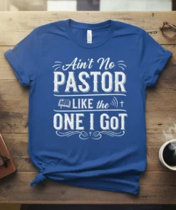 Ain't No PASTOR LIKE the ONE I GOT quote on a blue t-shirt, featuring a bible graphic and cross symbols