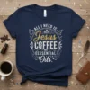 Navy t-shirt with "All I Need Is Jesus Coffee And Essential Oils" text in decorative gold and white font, featuring