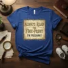 Always Read The Fine Print I'm Pregnant text on a blue t-shirt, announcing pregnancy
