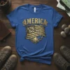 America Flag Tree Roots design with distressed American flag and golden text "AMERICA" on a royal blue t-shirt