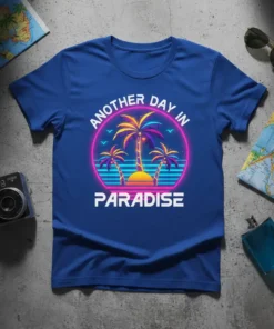 Retro "Another Day In Paradise" text with vibrant palm trees and sunset graphic on a blue t-shirt