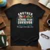 Black t-shirt with "Another School Year Survivor" and "The Longest School Year Ever" text, featuring school icons like books, apple