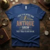 Blue t-shirt with "I went to an antique show, antique show, they tried to bid on me" text and a