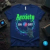 Anxiety ON OFF T-Shirt featuring green distressed text and a skeleton hand touching a glowing cube switch