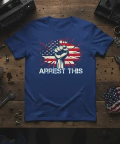 Arrest This slogan with a raised fist and distressed American flag graphic on a blue t-shirt