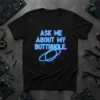 Black t-shirt with neon blue text "ASK ME ABOUT MY BUTTHOLE." and a blue ring graphic