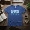 Blue t-shirt with white text "AUDIOBOOKS ARE READING" and a media player interface graphic below
