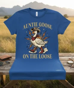 Auntie Goose On The Loose text with a cowboy goose graphic wearing boots and a bandana on a blue t-shirt