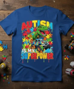 Autism Is My Superpower T-Shirt with a green dinosaur and monster truck on a colorful puzzle background