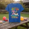 This is What An Awesome 7 Year Old Looks Like text with a rocket graphic on a blue t-shirt, celebrating