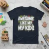 Awesome Like My Kids graffiti-style text on a dark navy t-shirt, with yellow, white, and red accents