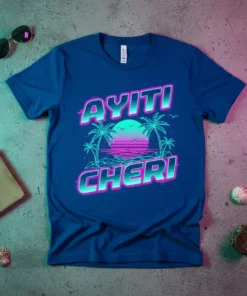 Ayiti Cheri text with retro sunset, palm trees, and geometric ocean design on a blue t-shirt