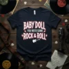 Baby Doll You Need Some Rock & Roll text with a guitar graphic on a navy t-shirt, vintage style