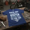 Blue t-shirt with white text "BACK OFF I HAVE A SISTER AND I'M NOT AFRAID TO USE HER" and a