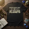 Black t-shirt with "Back In My Day We Had Nine Planets" text and planet graphics, featuring retro typography