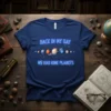 Back In My Day We Had Nine Planets text with solar system graphic on navy blue t-shirt