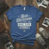 Bad Decisions Make Good Stories quote t-shirt with vintage adventure graphics like mountains, compass, and camera