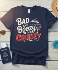 Navy blue t-shirt with white and red text reading "BAD AND Boozy ON THIS Cruisey," featuring a cartoon cruise ship