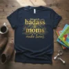 Navy t-shirt with gold foil text "badass moms make twins" and lion graphics, featuring the primary keyword