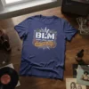 Navy blue t-shirt with "BLM Bang Local Milfs" in distressed white and gold lettering, featuring lightning bolt graphics
