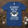 T-shirt design with the quote "BE CAREFUL WHO YOU TRUST SALT AND SUGAR LOOK THE SAME" and graphics of salt