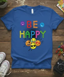 Blue t-shirt with "BE HAPPY" text in colorful emoji letters and a cluster of happy emoji faces below