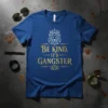 Blue t-shirt with gold text "Be Kind, It's Gangster" and a geometric lion wearing a crown