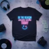 Neon graphic T-Shirt with the quote "BE THE REASON someone smiles TODAY" and a happy face design