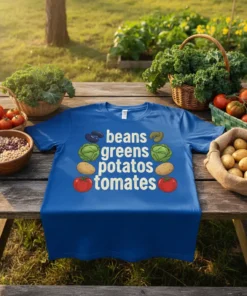 Blue t-shirt with "beans greens potatoes tomates" text and illustrations of vegetables like beans, cabbage, potatoes, and tomatoes
