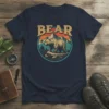 Vintage Bear graphic tee with a bear walking on rocks, mountains, and sunset in the background within a circle